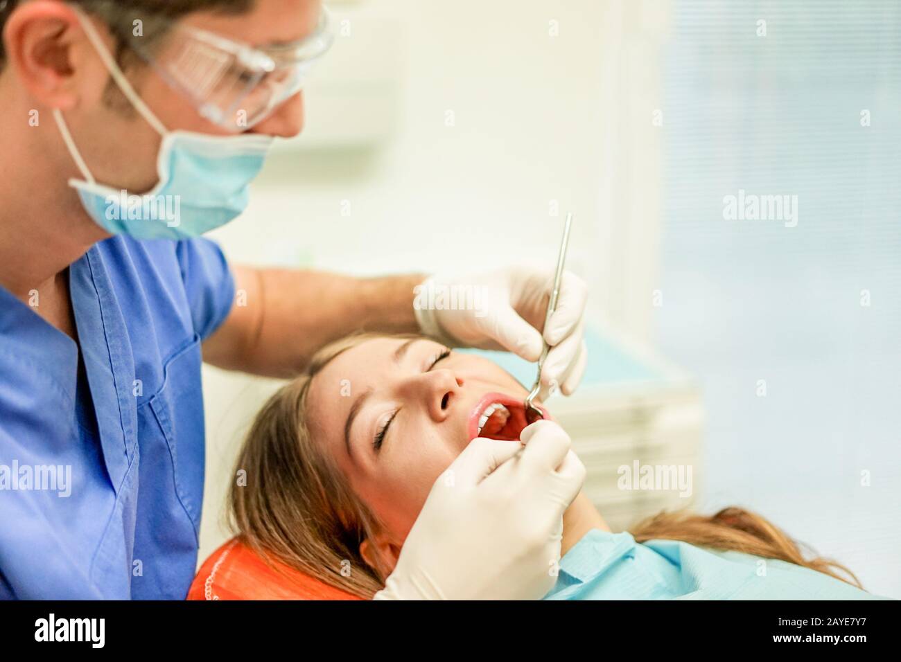 Young woman doing dental treatment - Girl having annual check visit by dentist - People bodycare and stomatology concept for healthy lifestyle - Focus Stock Photo