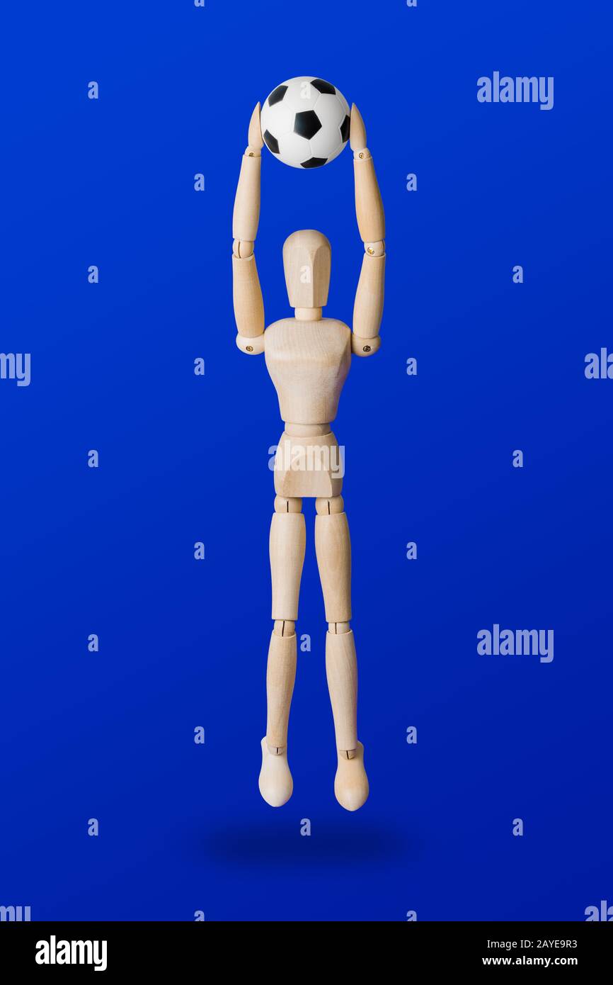 Football wooden toy figure on blue Stock Photo Alamy