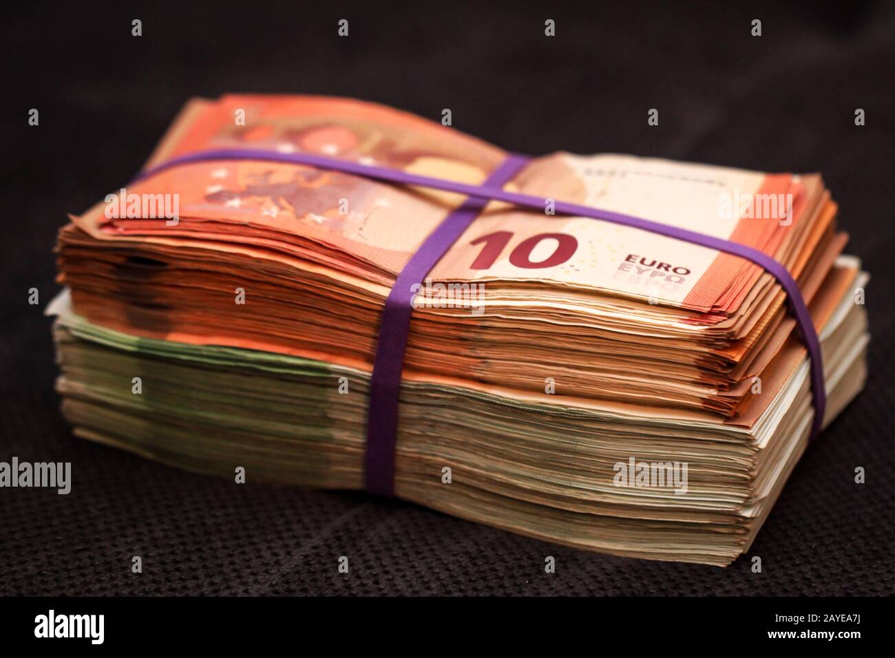 many bills, euro bills bundled on a pile Stock Photo