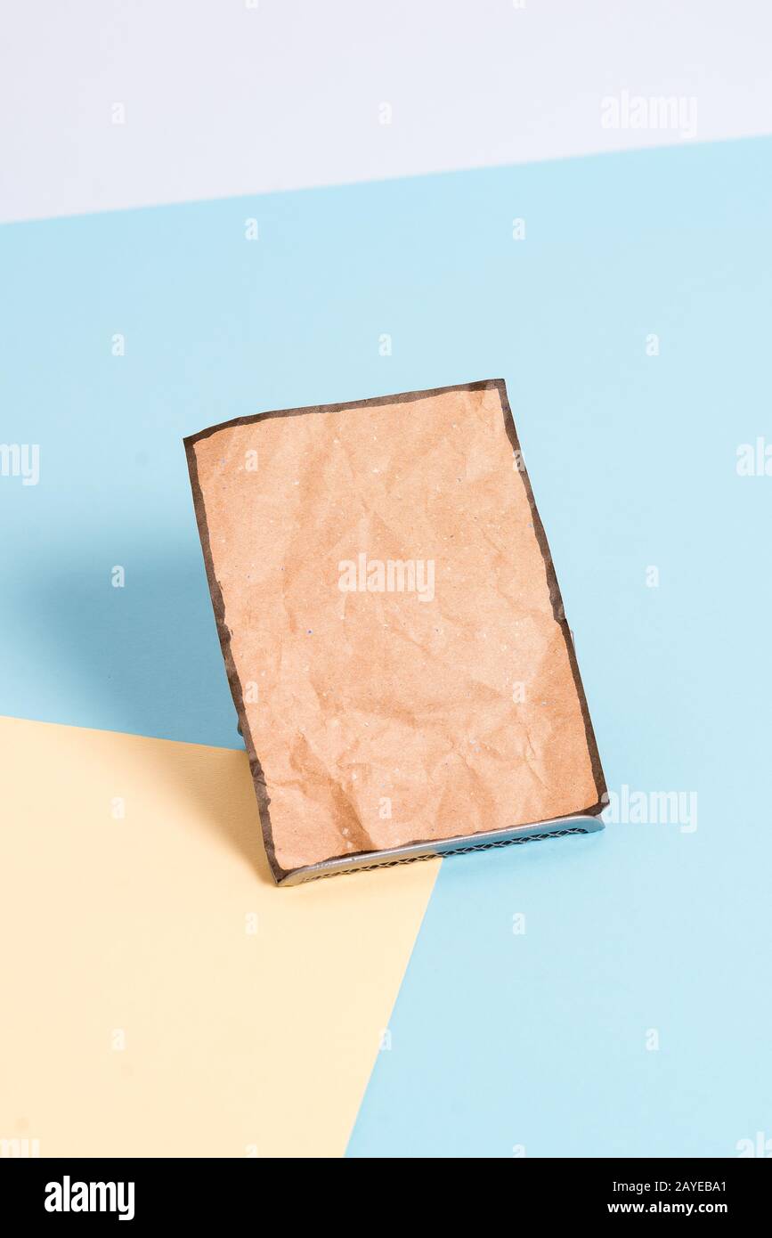 Paper sheet placed tilted on a buffer wire with a soft pastel backdrop