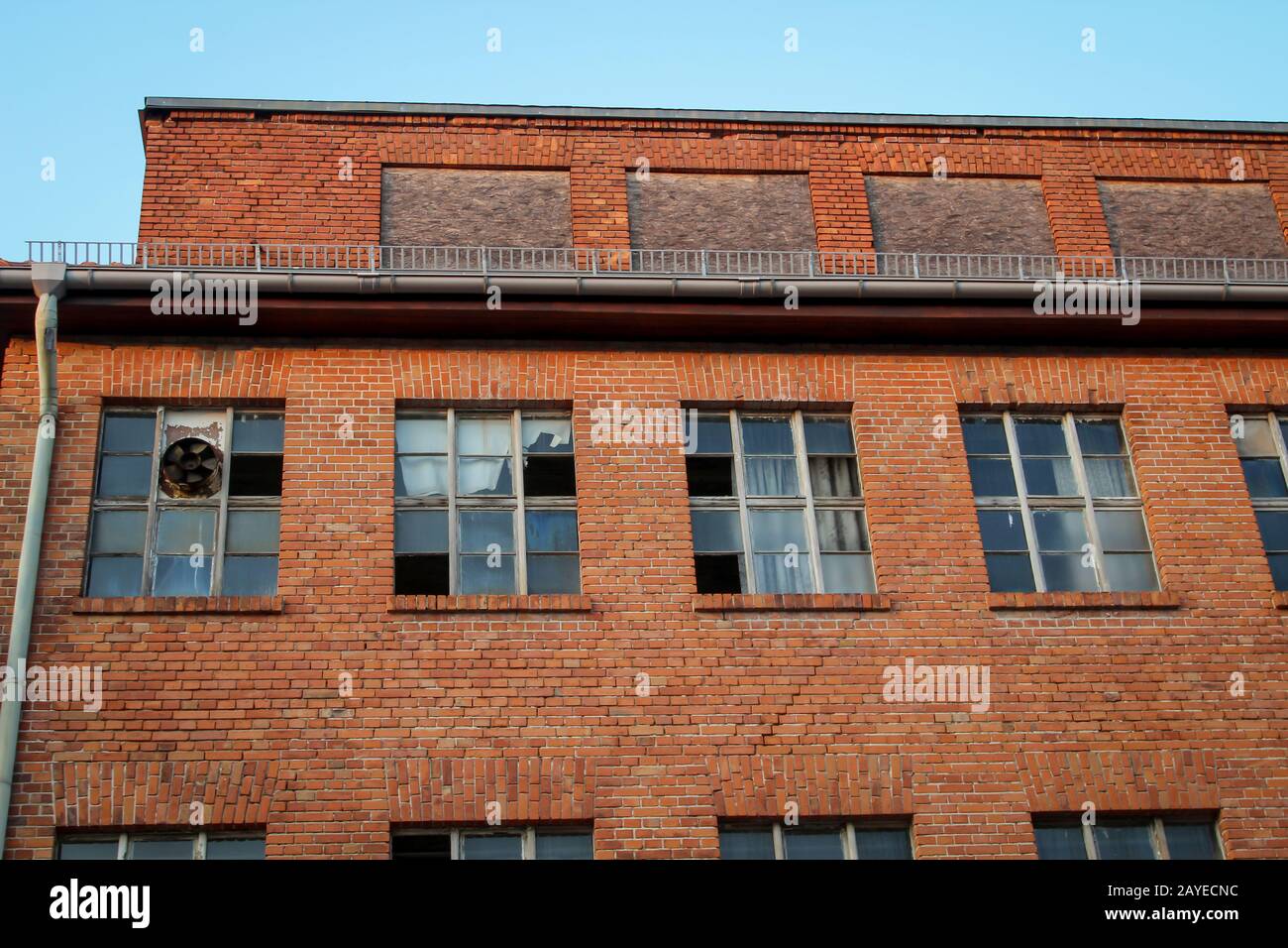 View of an old former factory with broken windows Stock Photo