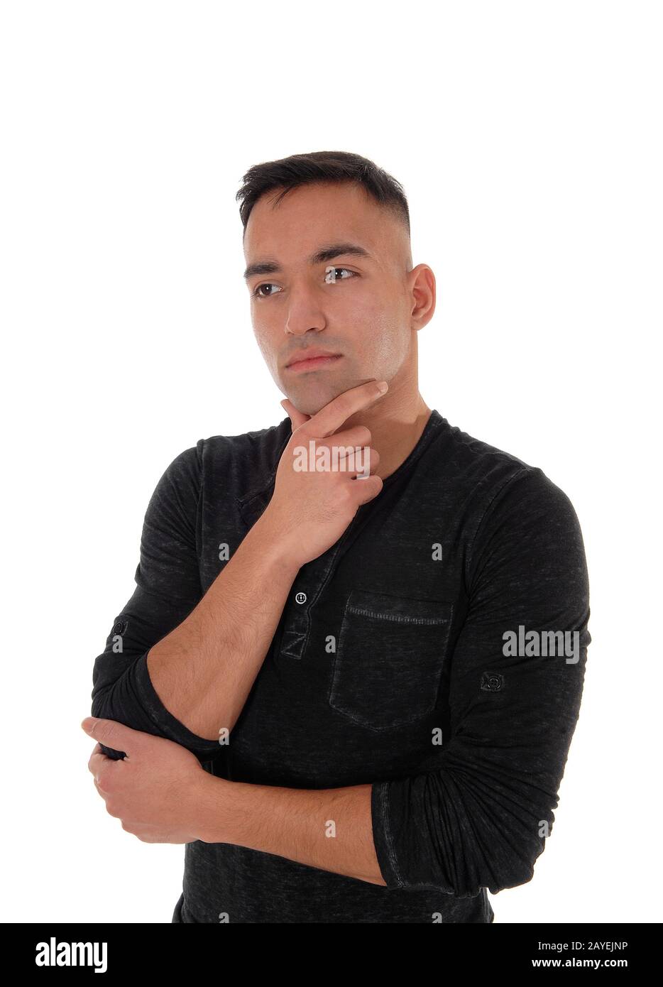 Young businessman standing in a black shirt thinking Stock Photo