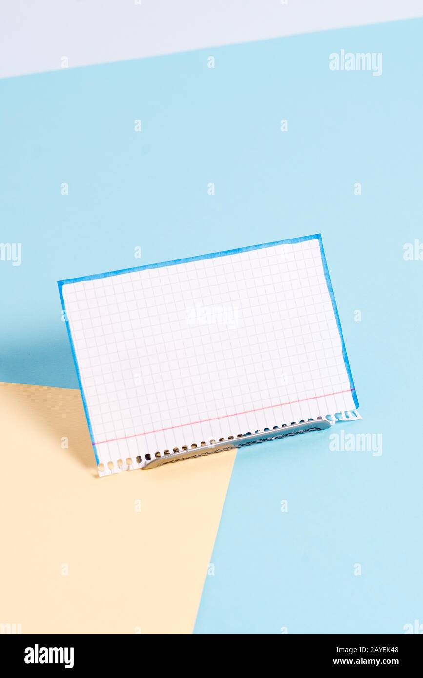 Paper sheet placed tilted on a buffer wire with a soft pastel backdrop