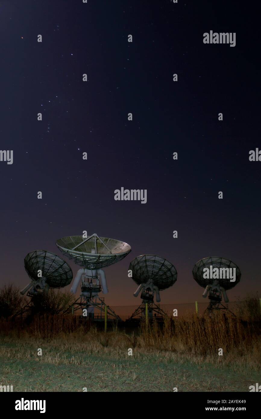 Arcminute Microkelvin Imager (AMI) Large array antennae. A cosmic microwave background (CMB) Radio telescope, Mullard Observatory Cambridge. Stock Photo