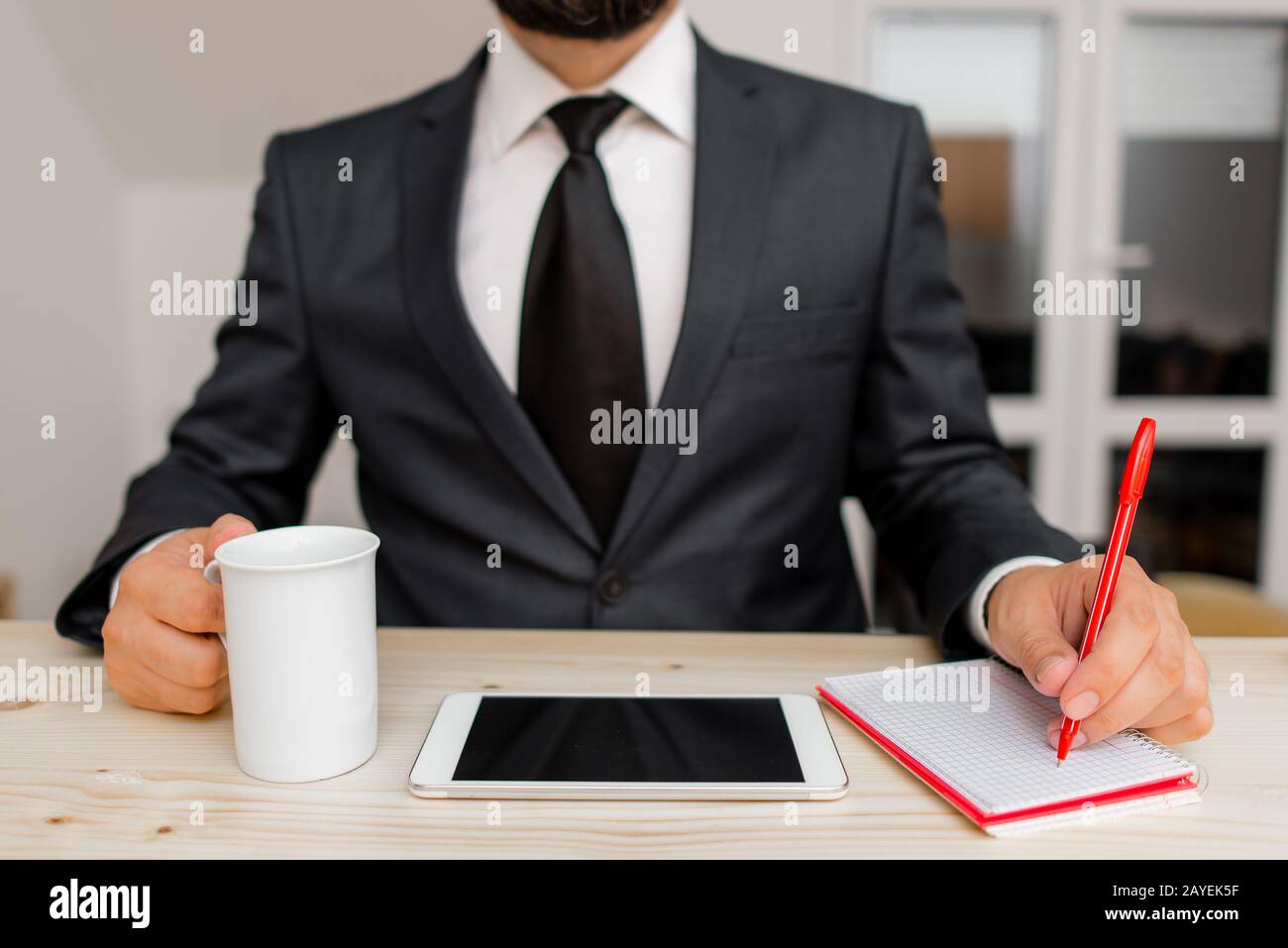 Male human wear formal working clothes presenting presentation of high technology smartphone device. Man dressed in work suit pl Stock Photo