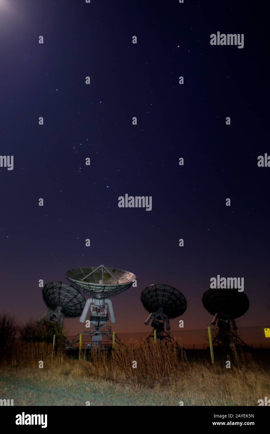 Arcminute Microkelvin Imager (AMI) Large array antennae. A cosmic microwave background (CMB) Radio telescope, Mullard Observatory Cambridge. Stock Photo