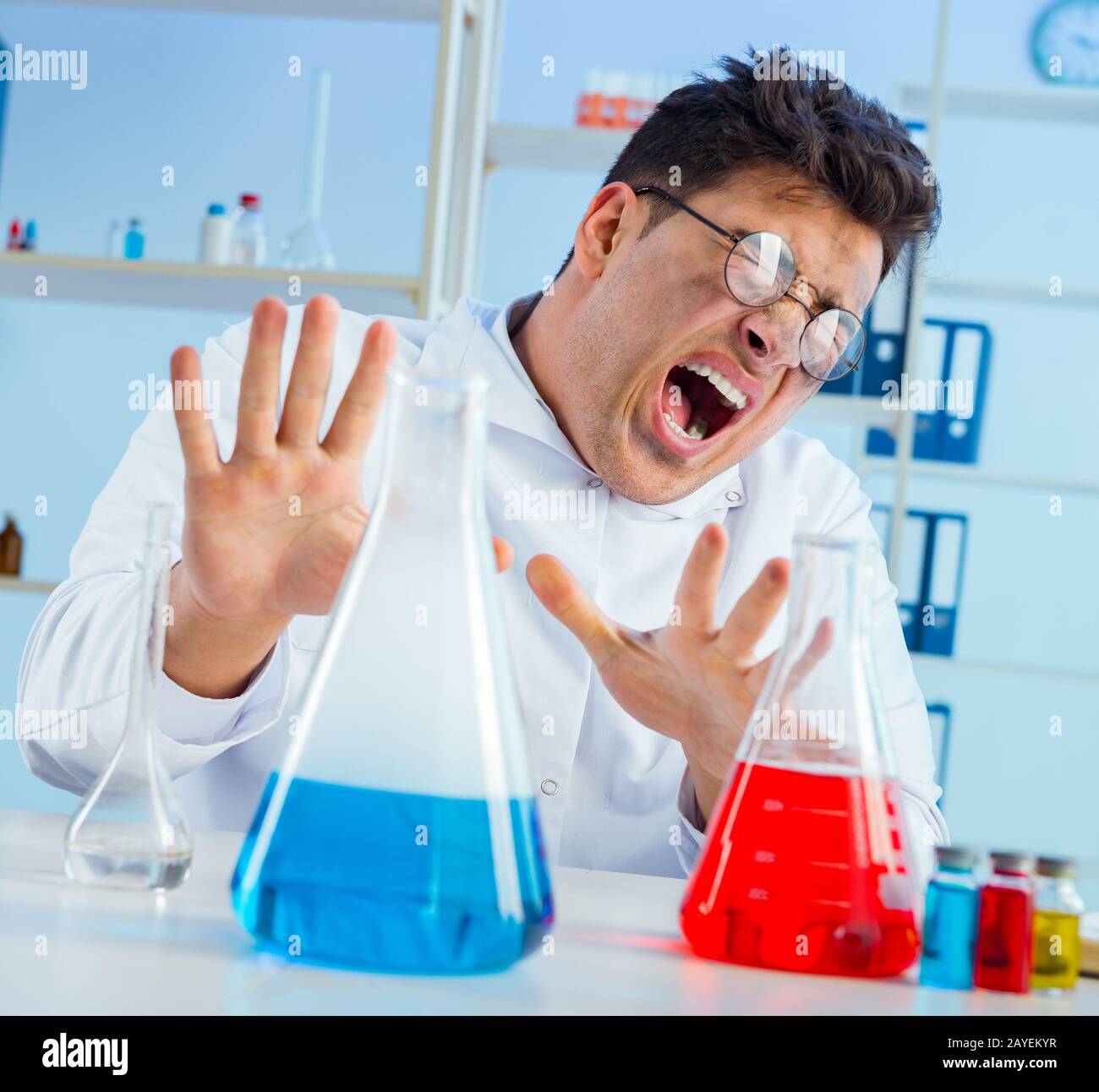 Funny mad chemist working in a laboratory Stock Photo