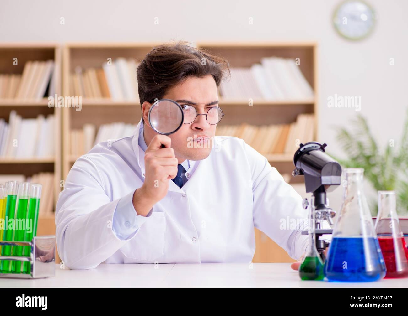 Mad crazy scientist doctor doing experiments in a laboratory Stock Photo