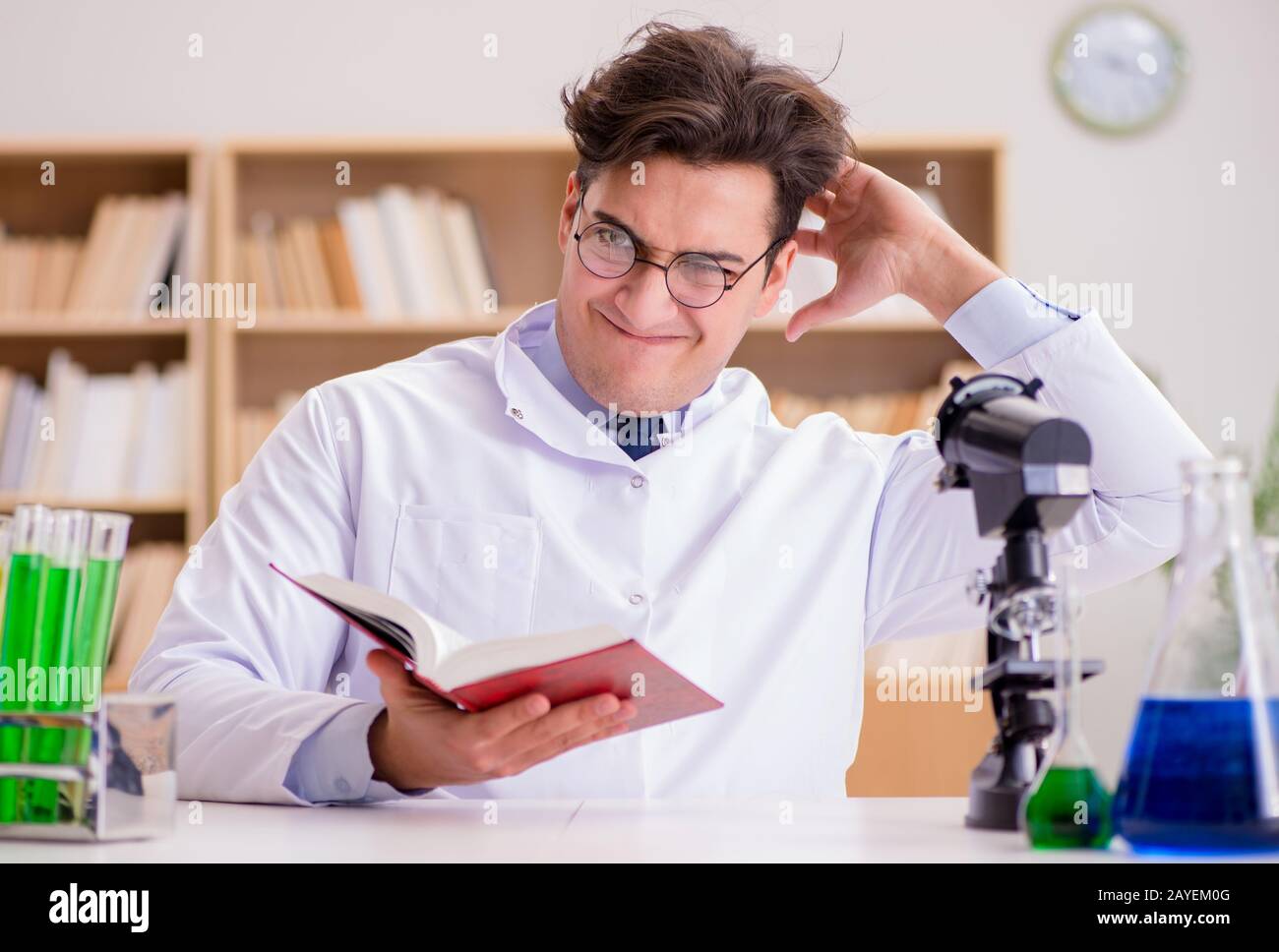 Mad crazy scientist doctor doing experiments in a laboratory Stock Photo