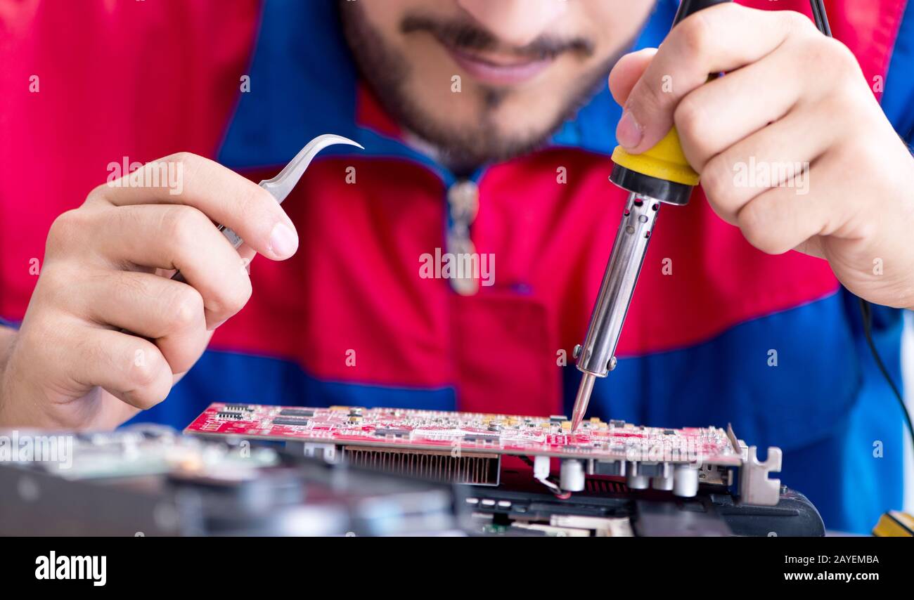 Repairman working in technical support fixing computer laptop tr Stock Photo