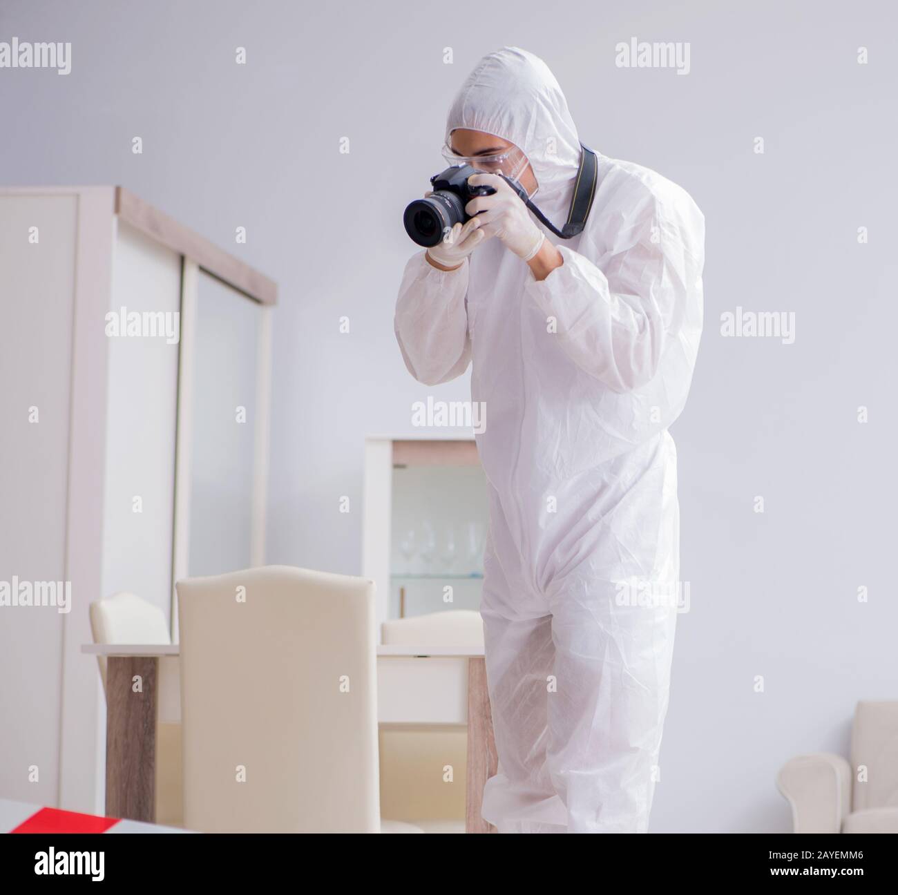 Forensic expert at crime scene doing investigation Stock Photo