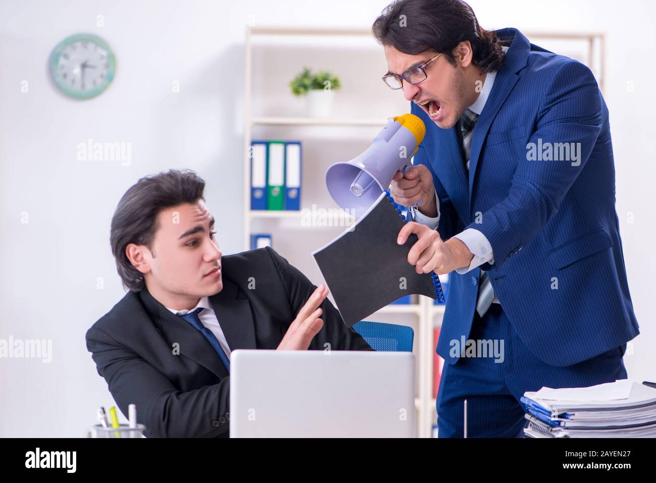 Boss and his male assistant working in the office Stock Photo - Alamy