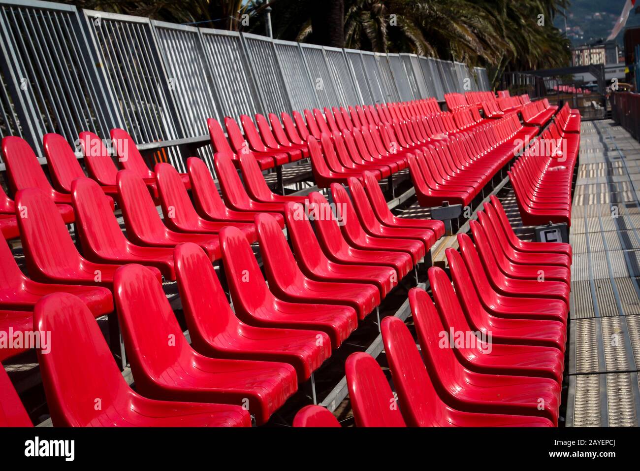 a lot of red plastic seats of a tribune Stock Photo