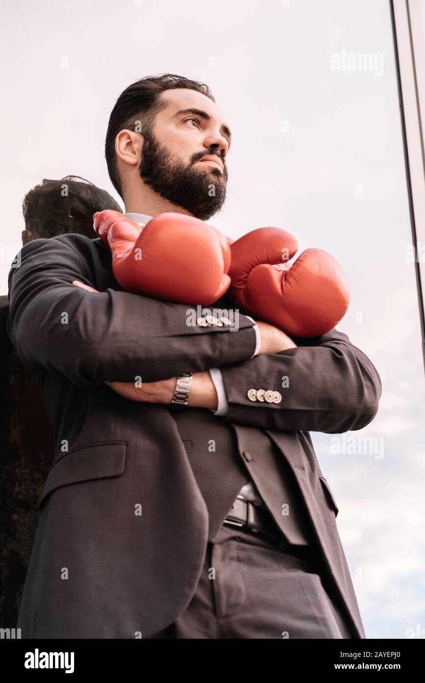 Vertical photo of a businessman in a suit with his arms crossed, with