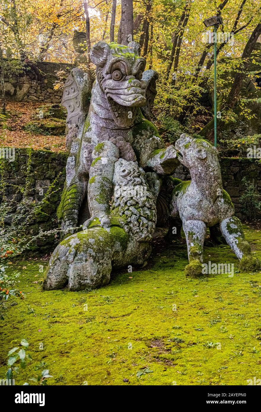 Italy, Lazio, the Bomarzo garden Of Monster ( Giardino Dei Mostri ) - Dragon  fighting a dog, a wolf, a lion Stock Photo - Alamy