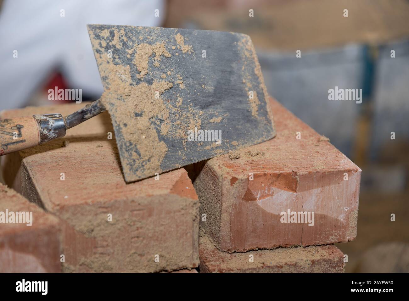 Trowel and small bricks - close-up of smoothing trowel Stock Photo