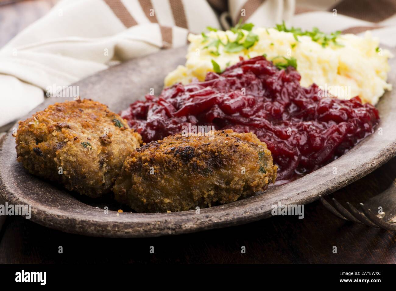 Prepared dinner on the plate. Melted meat, potatoes, beetroot Stock Photo