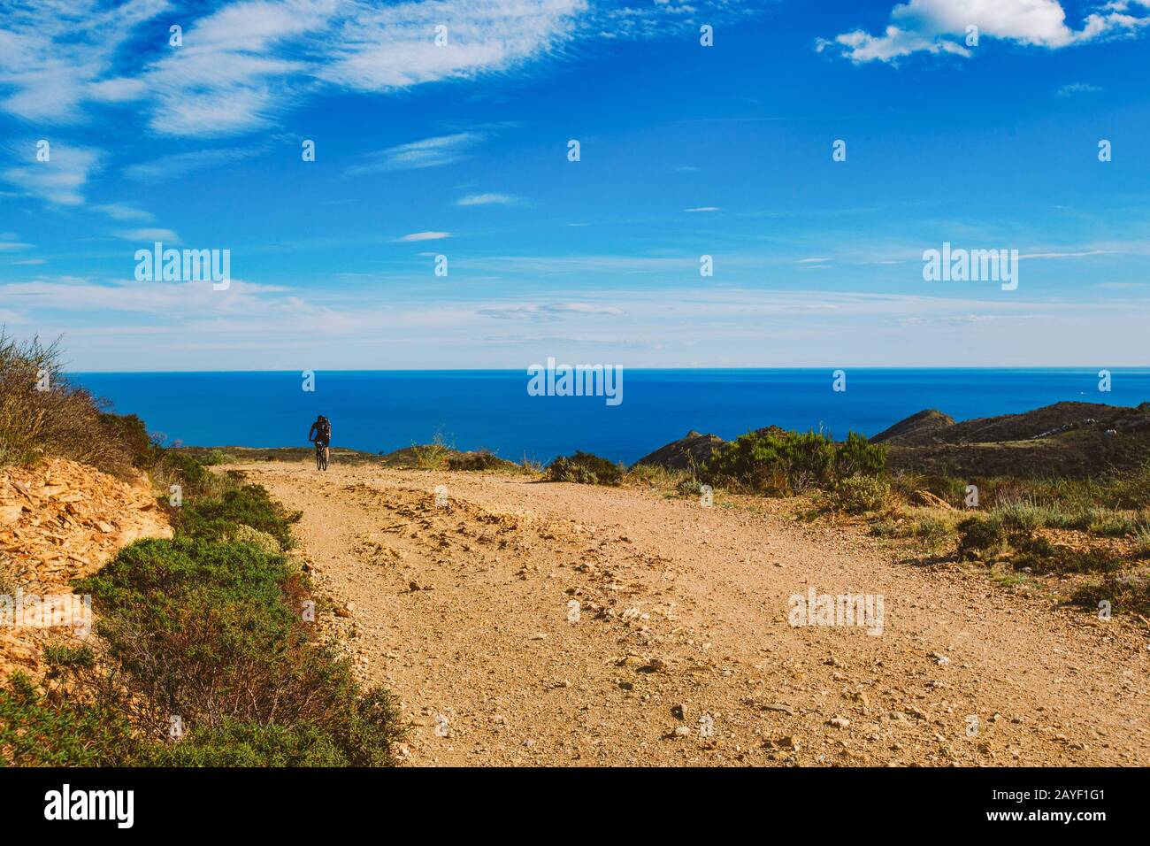 a young guy riding a mountain bike on a bicycle route in Spain on road