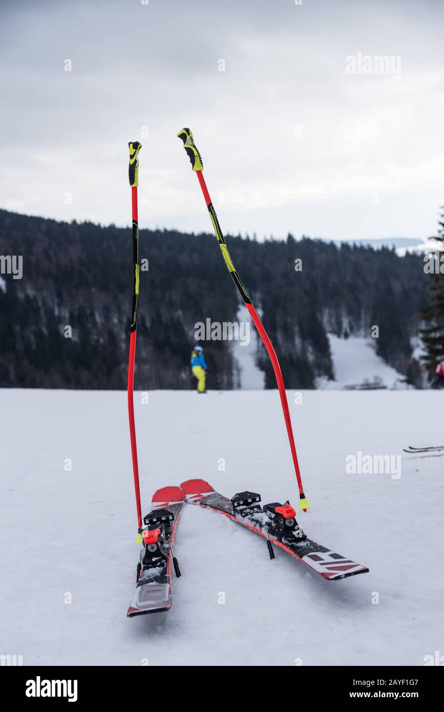Ski poles and skis in the snow - skiers take a break Stock Photo