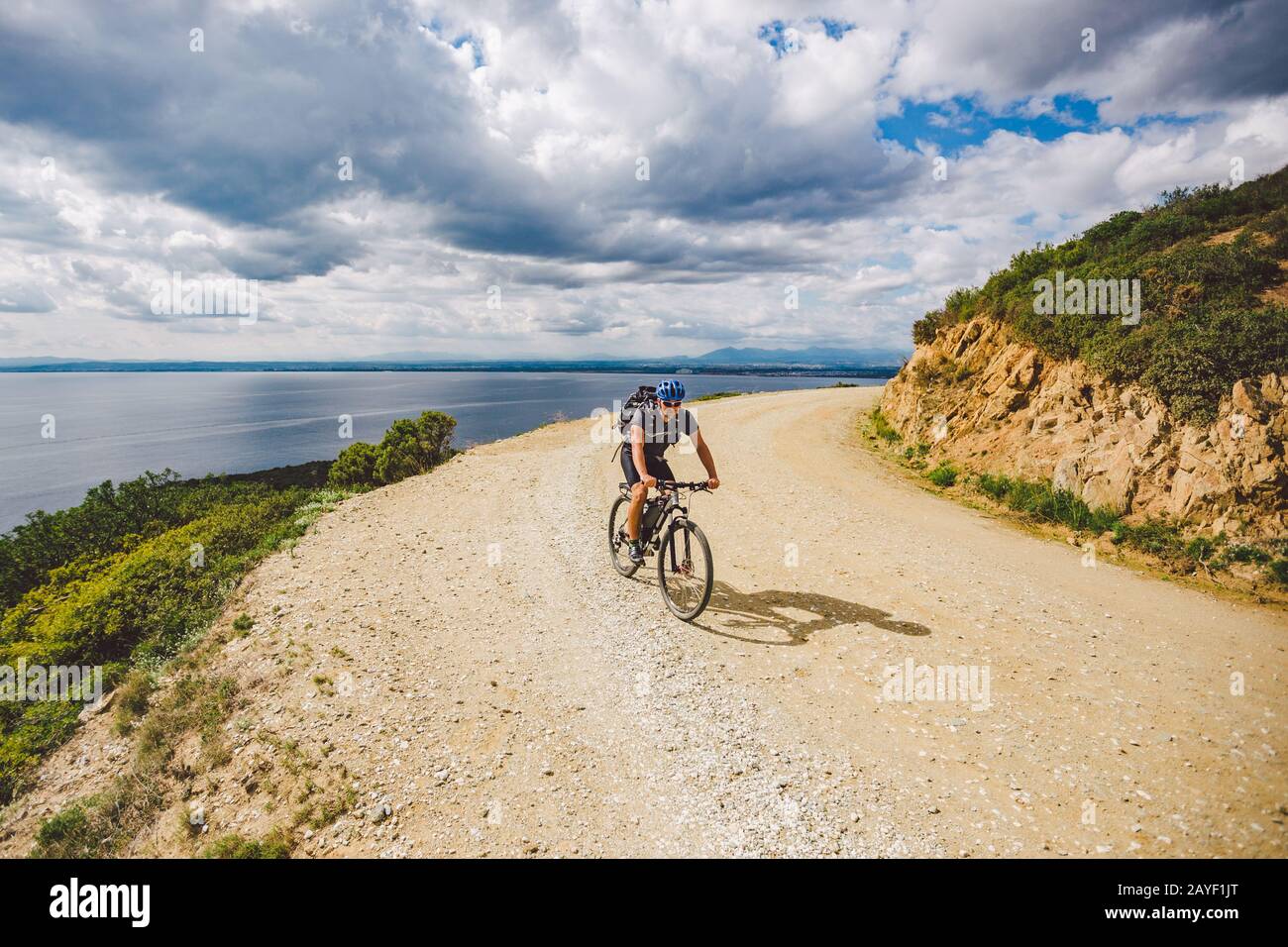 young guy riding a mountain bike on a bicycle route in Spain. Athlete