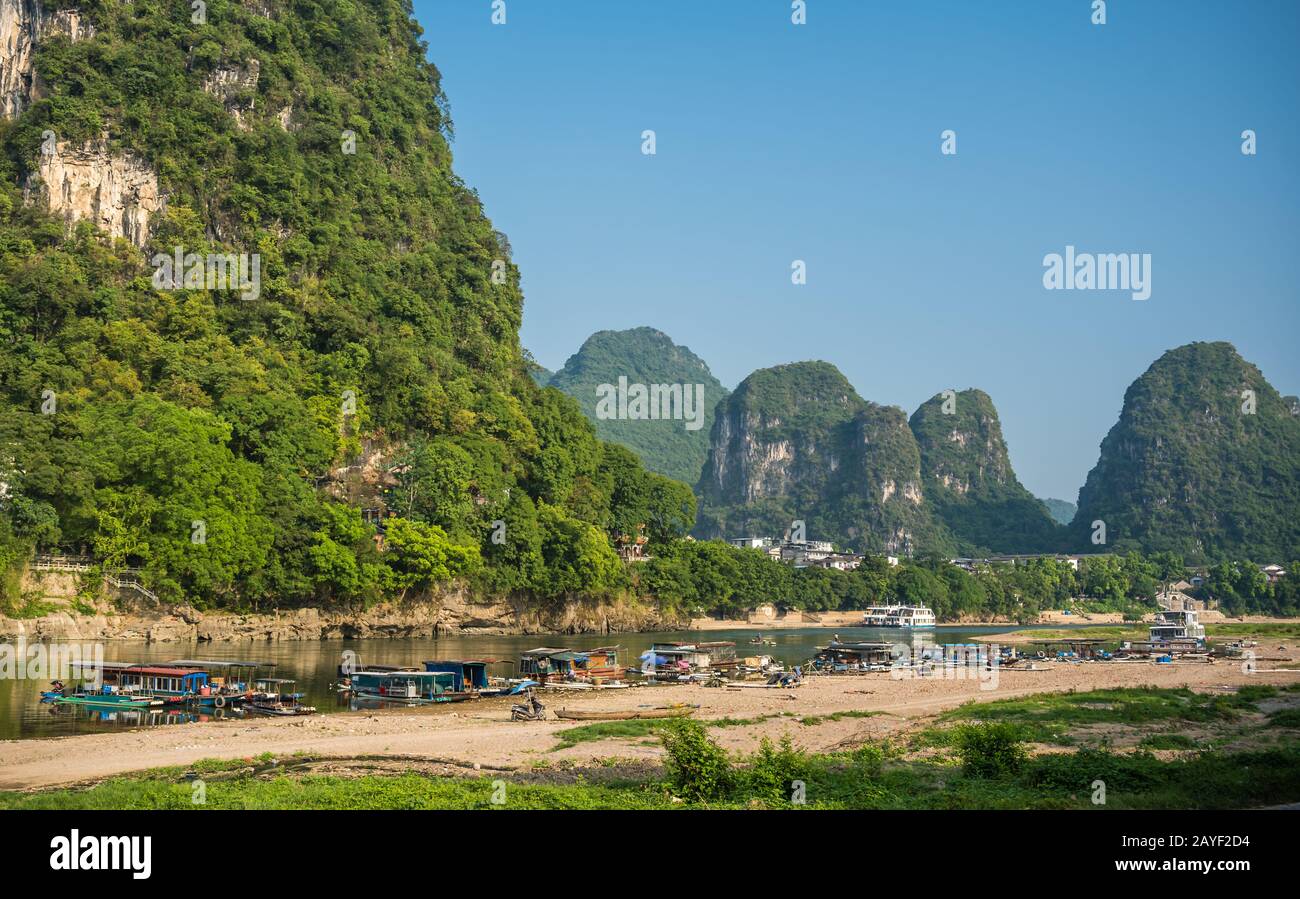 Small boats on the shore of Li River in Yangshuo Stock Photo