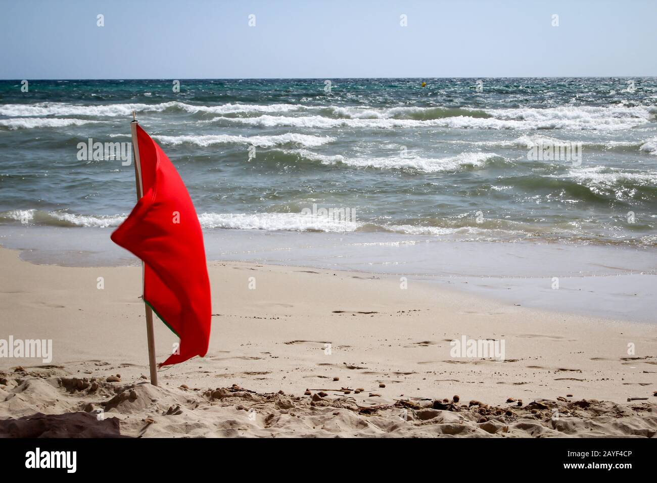 Flags on the beach indicate dangers like jellyfish, undercurrent and other dangers Stock Photo