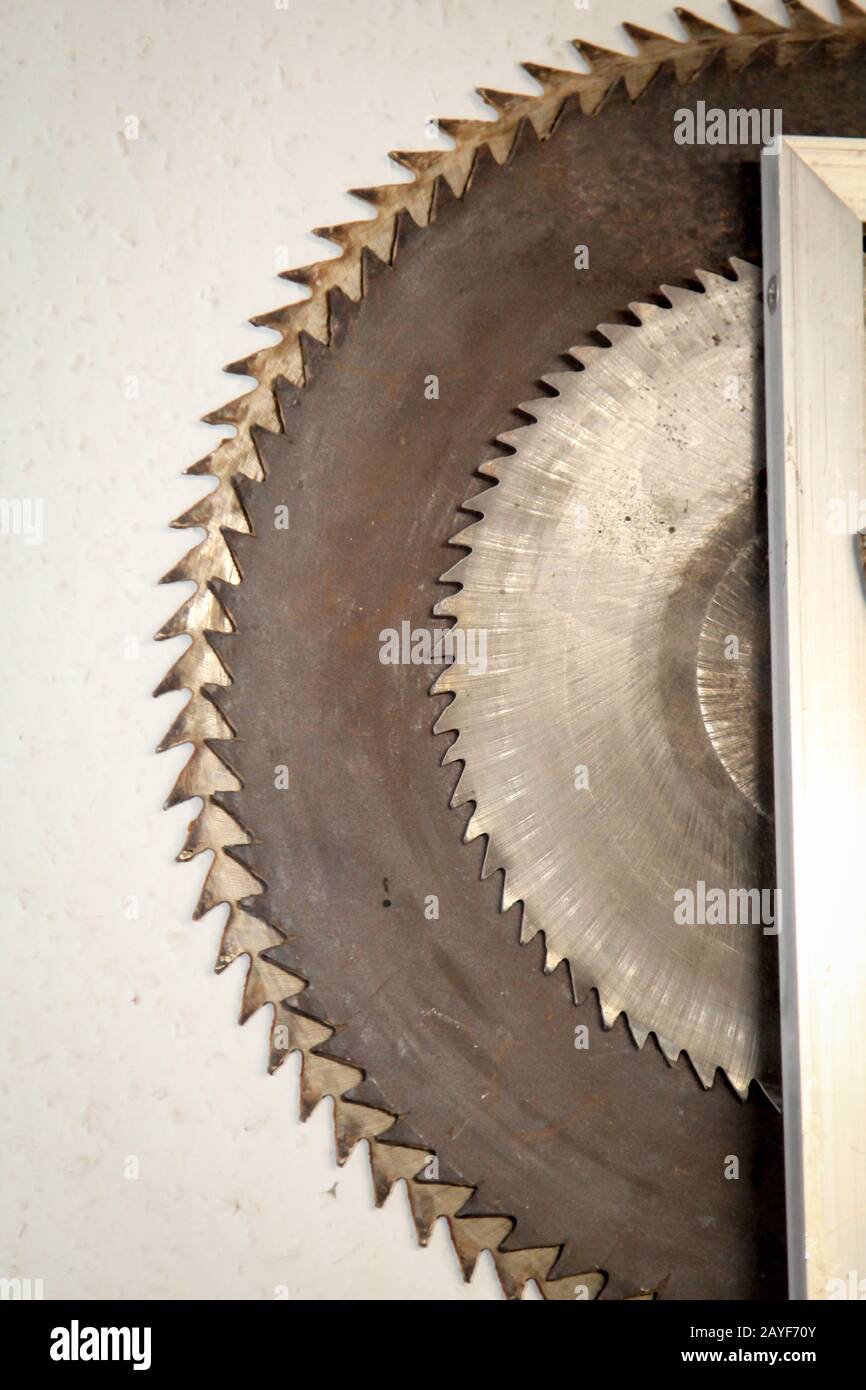 several saw blades for a circular saw hanging on a wall Stock Photo