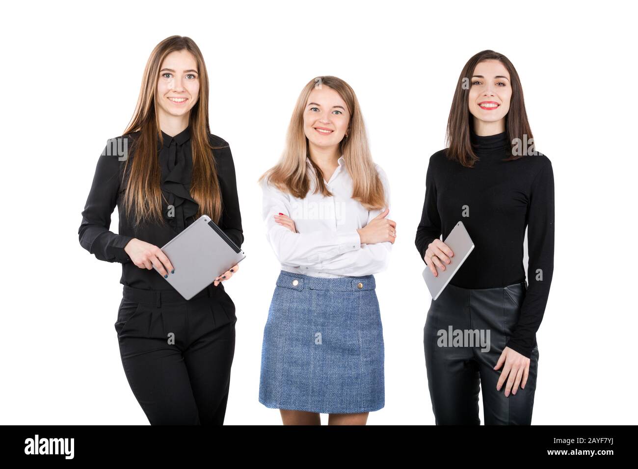 Three smiling business women standing in a row isolated on white ...