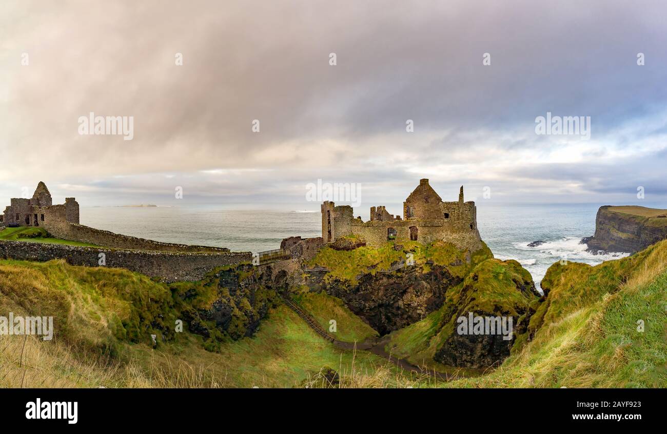Ruins of Dunluce Castle on the edge of cliff. Filming location of popular TV show. Stock Photo