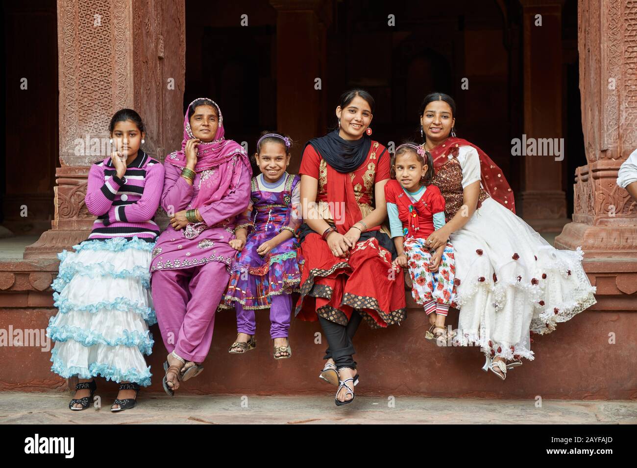 Group of traditionally dressed women and girls inside Agra Fort, Agra, Uttar Pradesh, India Stock Photo