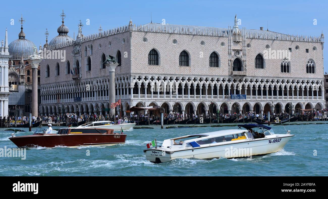 Motor launches pass the Doge's Palace from Saint Mark's Basin, Venice, Italy, Europe. Stock Photo