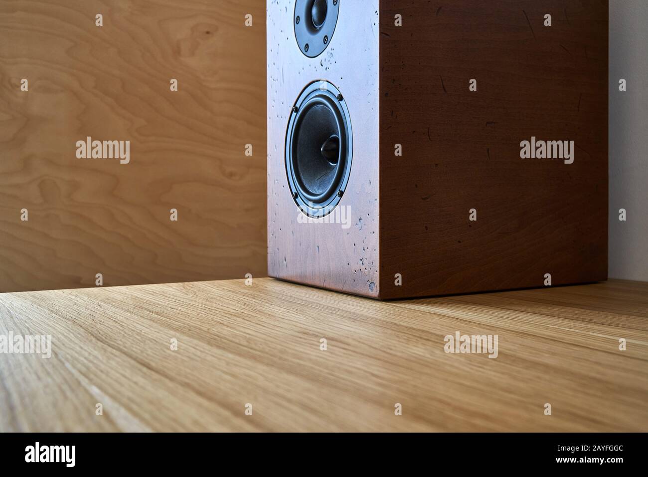 Diy Bookshelf Speaker Standing On A Table Against The Plywood Wall Stock Photo Alamy