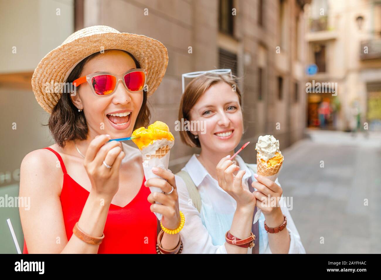 Premium Photo  Multiethnic friends in an ice cream parlor sitting eating  an ice cream summer showing off the ice creams