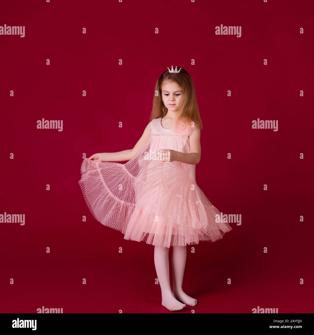 Beautiful little girl princess dancing in luxury pink and silver dress ...