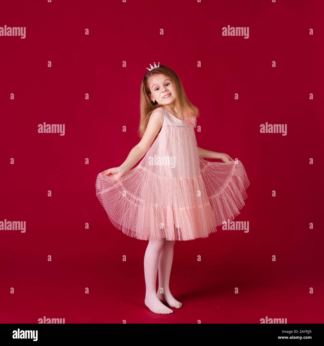 Beautiful little girl princess dancing in luxury pink and silver dress ...