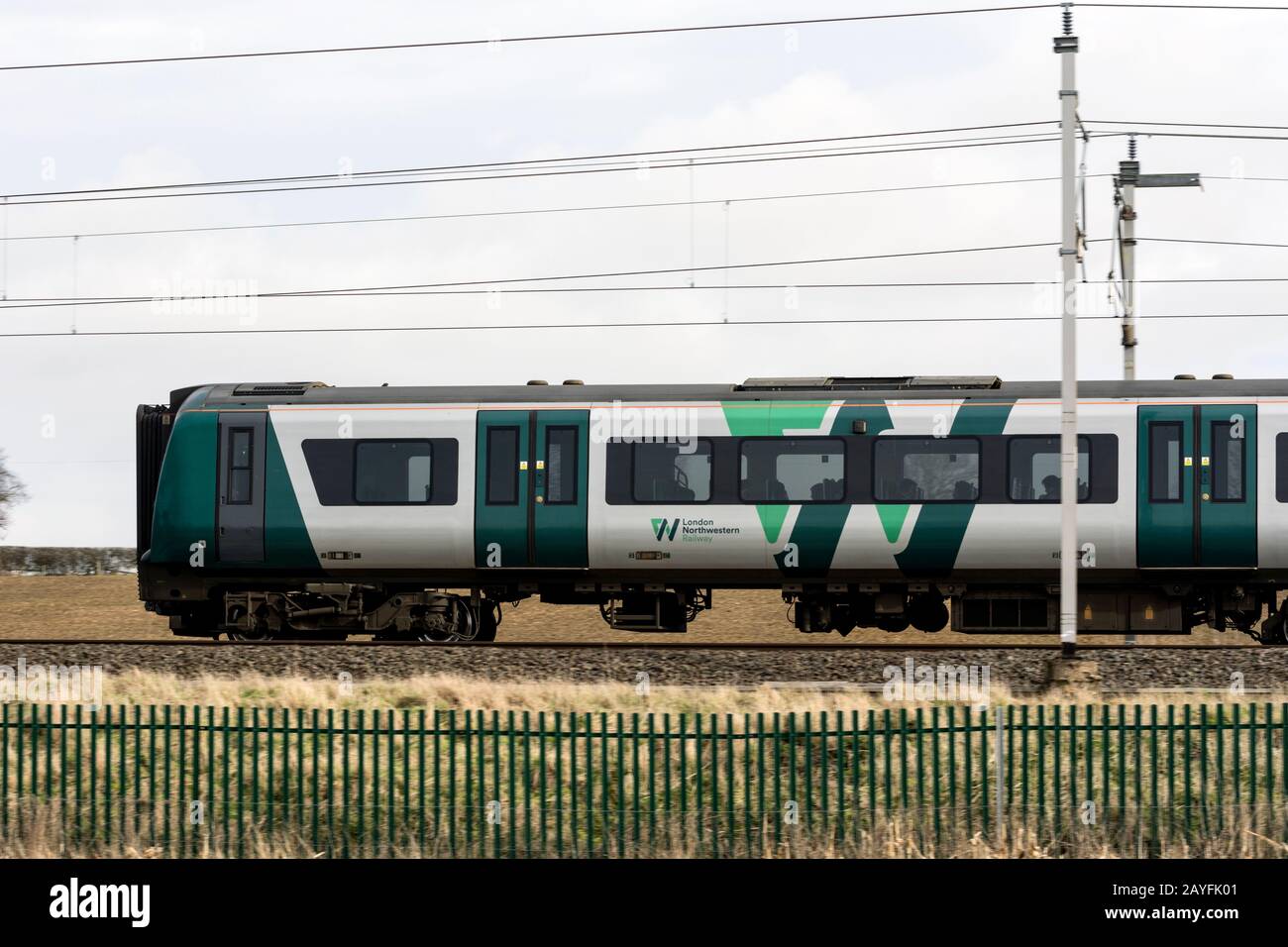 London Northwestern Railway class 350 eletric train at speed, side view, Northamptonshire, UK Stock Photo