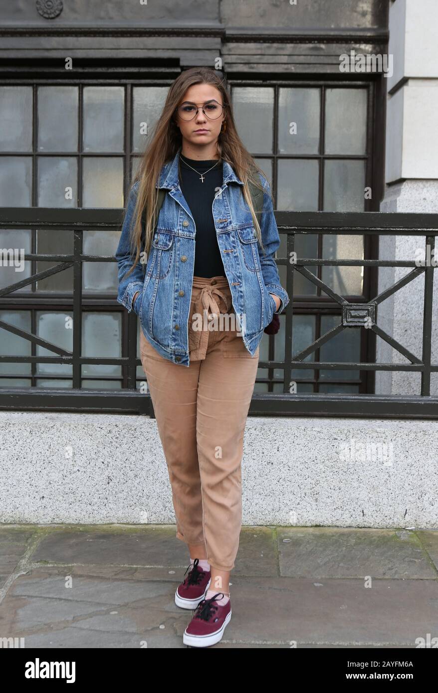 Fashion Enthusiast poses for a photo as she attends the London Fashion