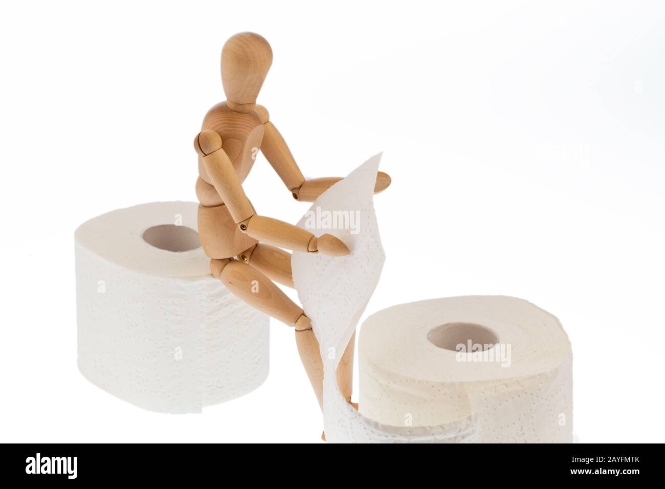 Eine Holzfigur und eine Rolle Toilettenpapier Stock Photo