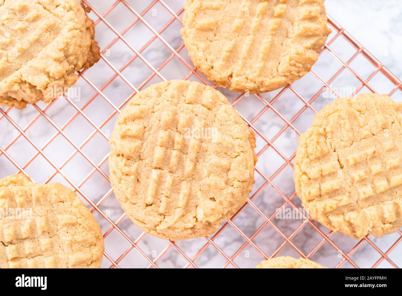 Freshly baked peanut butter cookies cooling on a drying rack Stock
