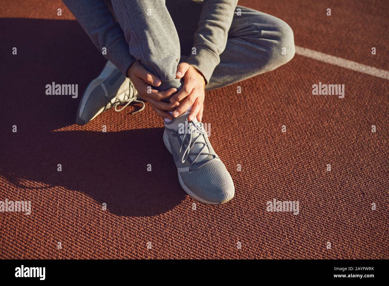 Knee injury in training.Man injured his leg during exercise. Stock Photo