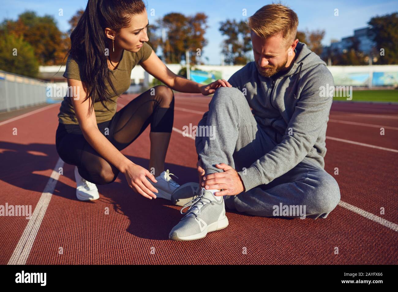 Knee injury in training. A male injured his leg during exercise Stock