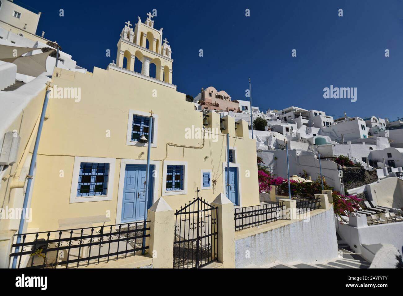 Yellow church on the edge of the town of Fira on Santorini island, Greece. Stock Photo