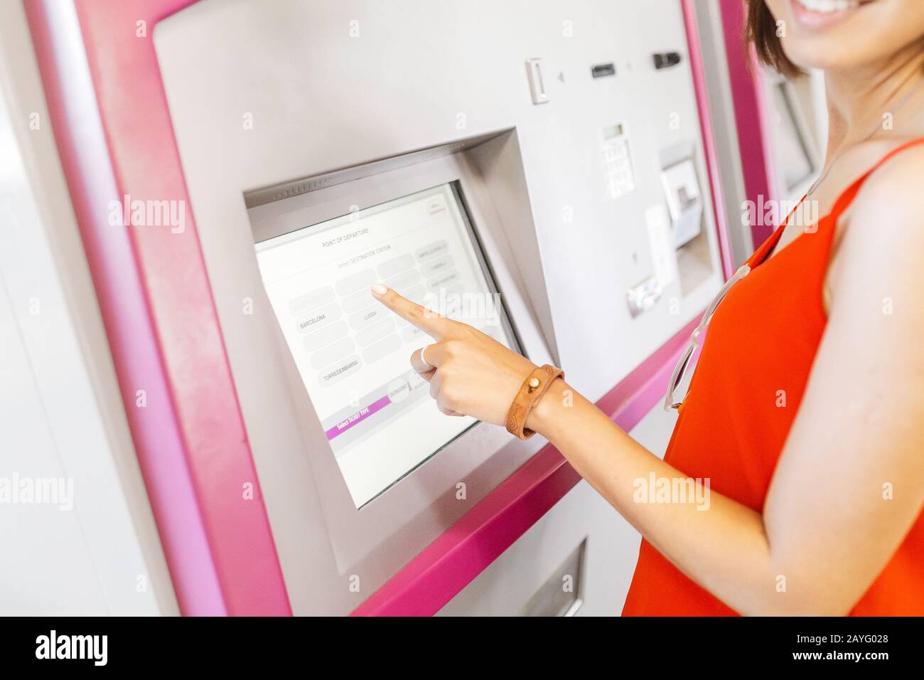 Young woman paying at ticket machine in a metro or railroad station Stock Photo
