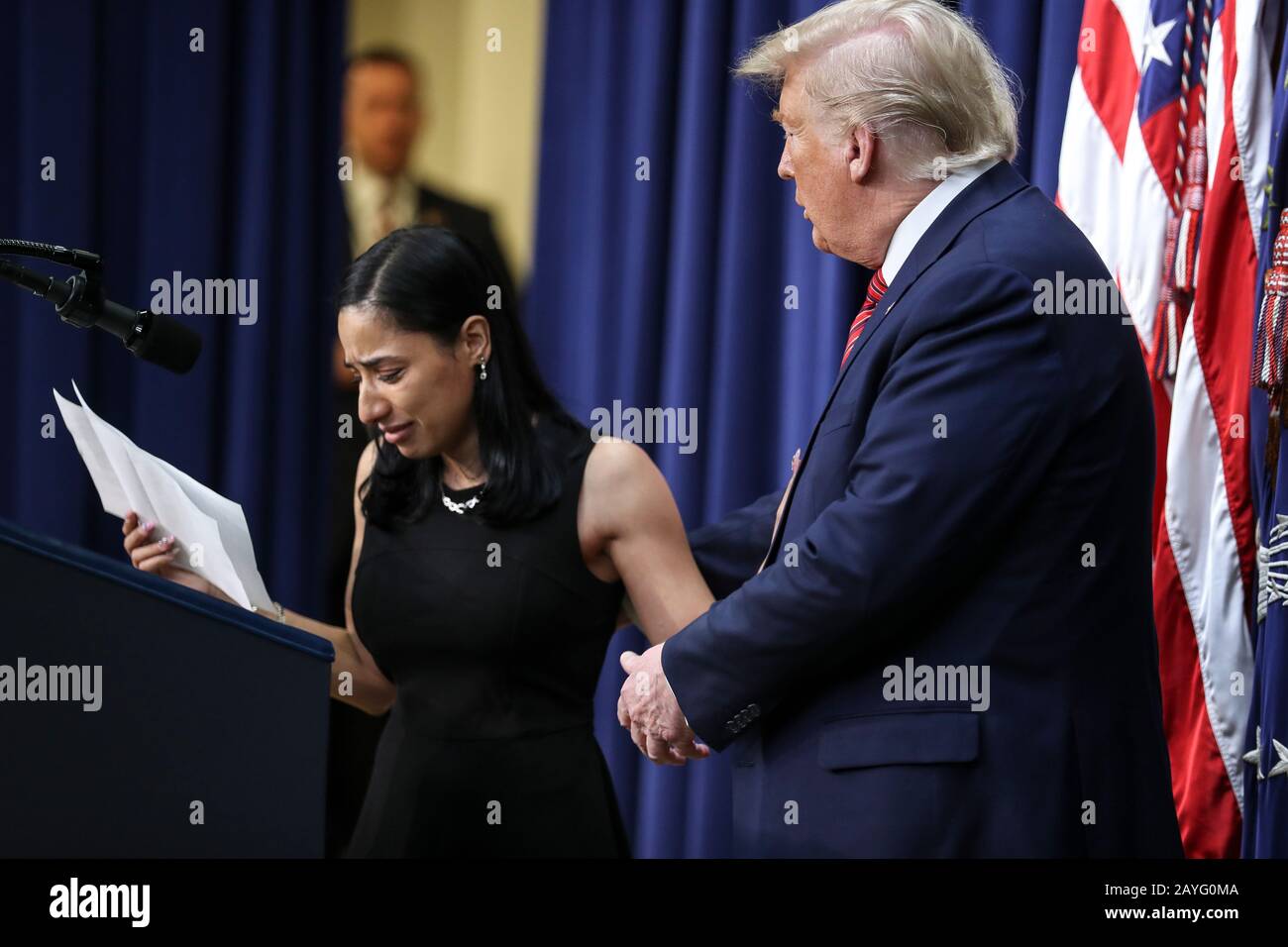 Washington DC, USA. 15th Feb 2020. President Donald Trump tries to comfort Daria Ortiz who recounted the death of her grandmother, allegedly by a man who was living in the country without legal permission, speaks, during a speech to members of the National Border Patrol Council in the South Court Auditorium at the Eisenhower Executive Office Building on the White House complex on February 14, 2020 in Washington, DC. (Photo by Oliver Contreras/SIPA USA) Credit: Sipa USA/Alamy Live News Stock Photo
