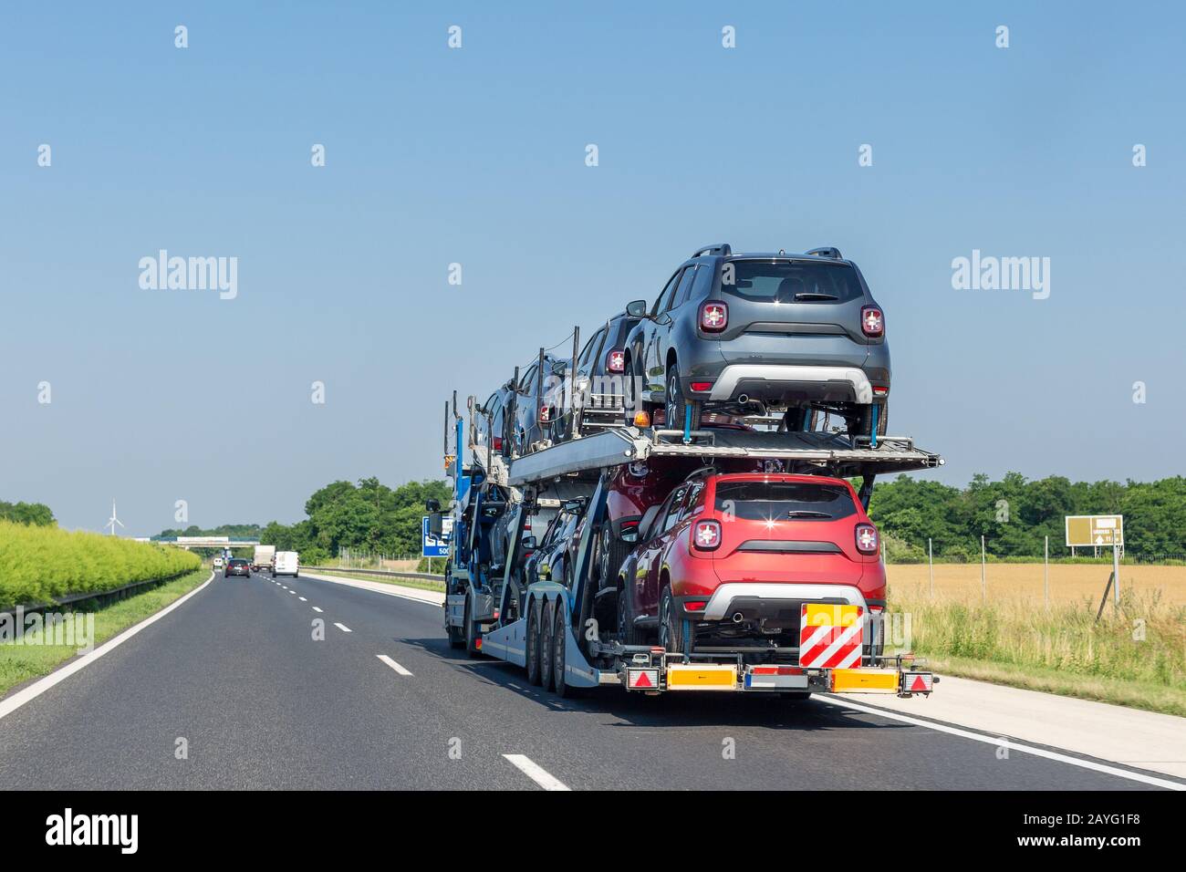 Big car carrier truck with new cars on the highway Stock Photo