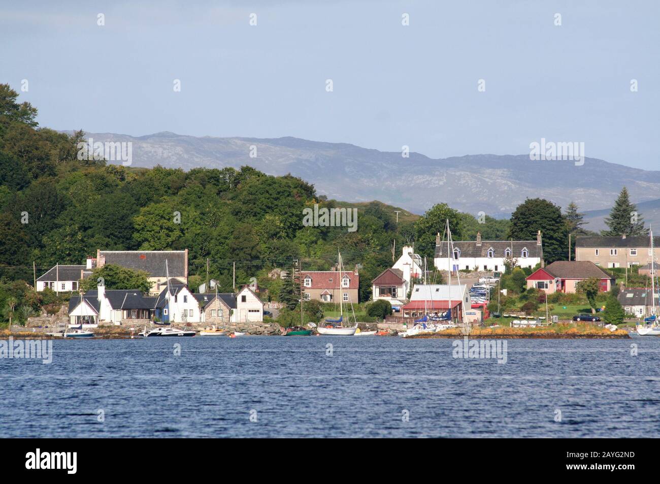 Tayvallich village and boats in the harbour from the water, Loch Sween, Argyll, Scotland Stock Photo