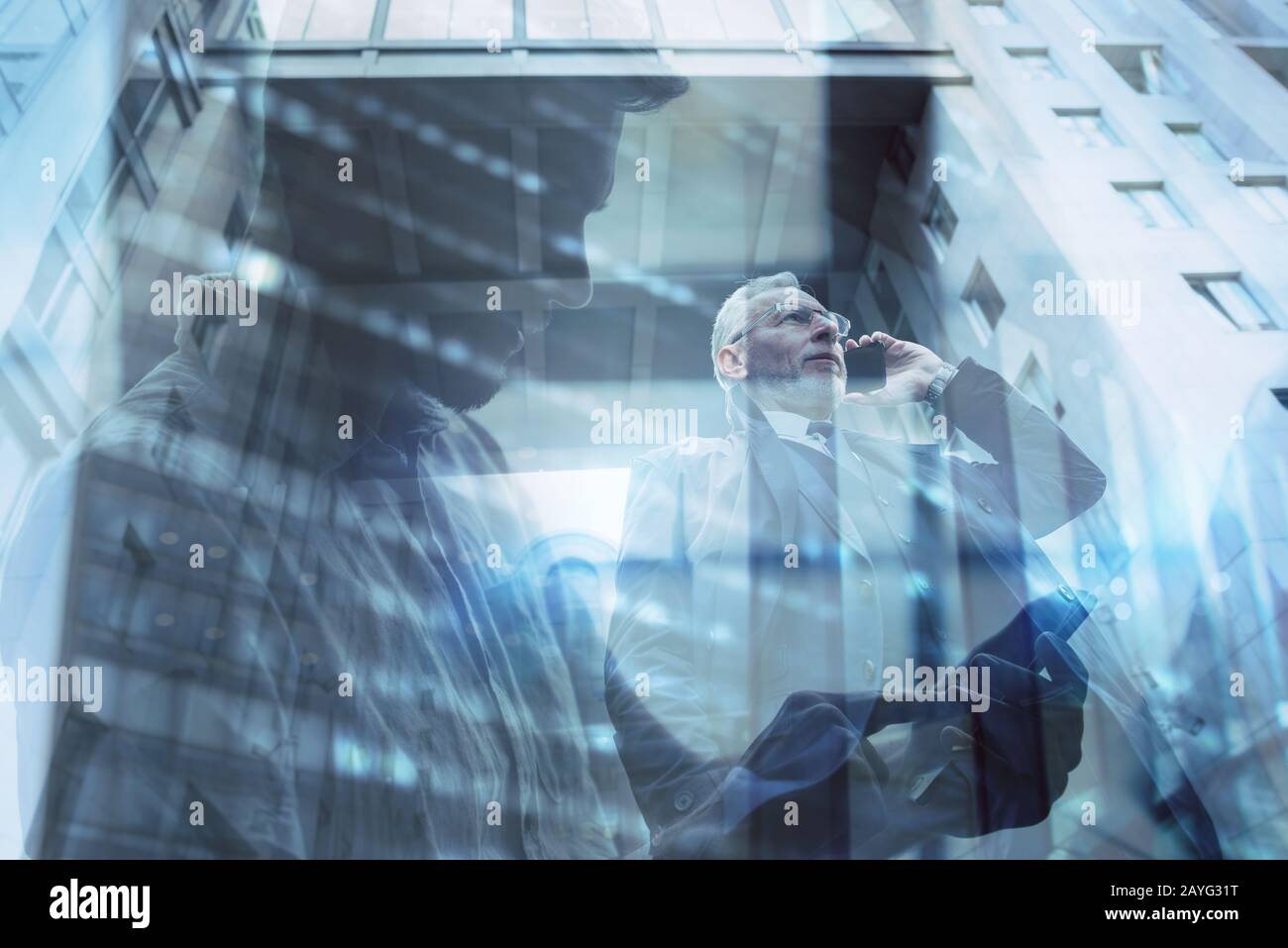 Senior businessman speaks on the mobile while walking in a modern city. Double exposure effect Stock Photo