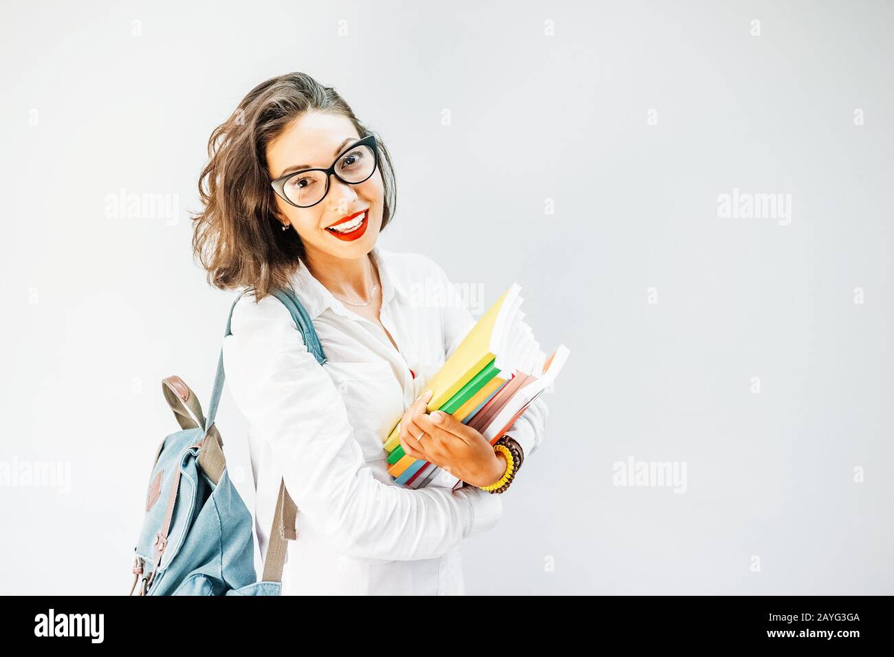 Portrait of a happy girl student or young teacher with backpack and ...