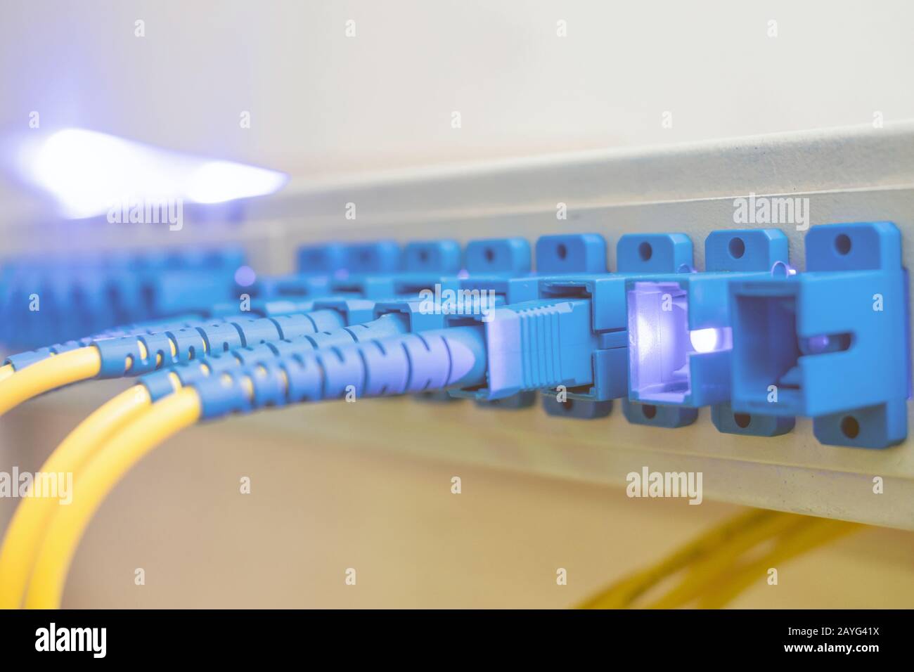 A powerful internet signal shines with the Optical Fiber Distribution Frame Equipment for access to the Internet. The concept of modern high-speed com Stock Photo