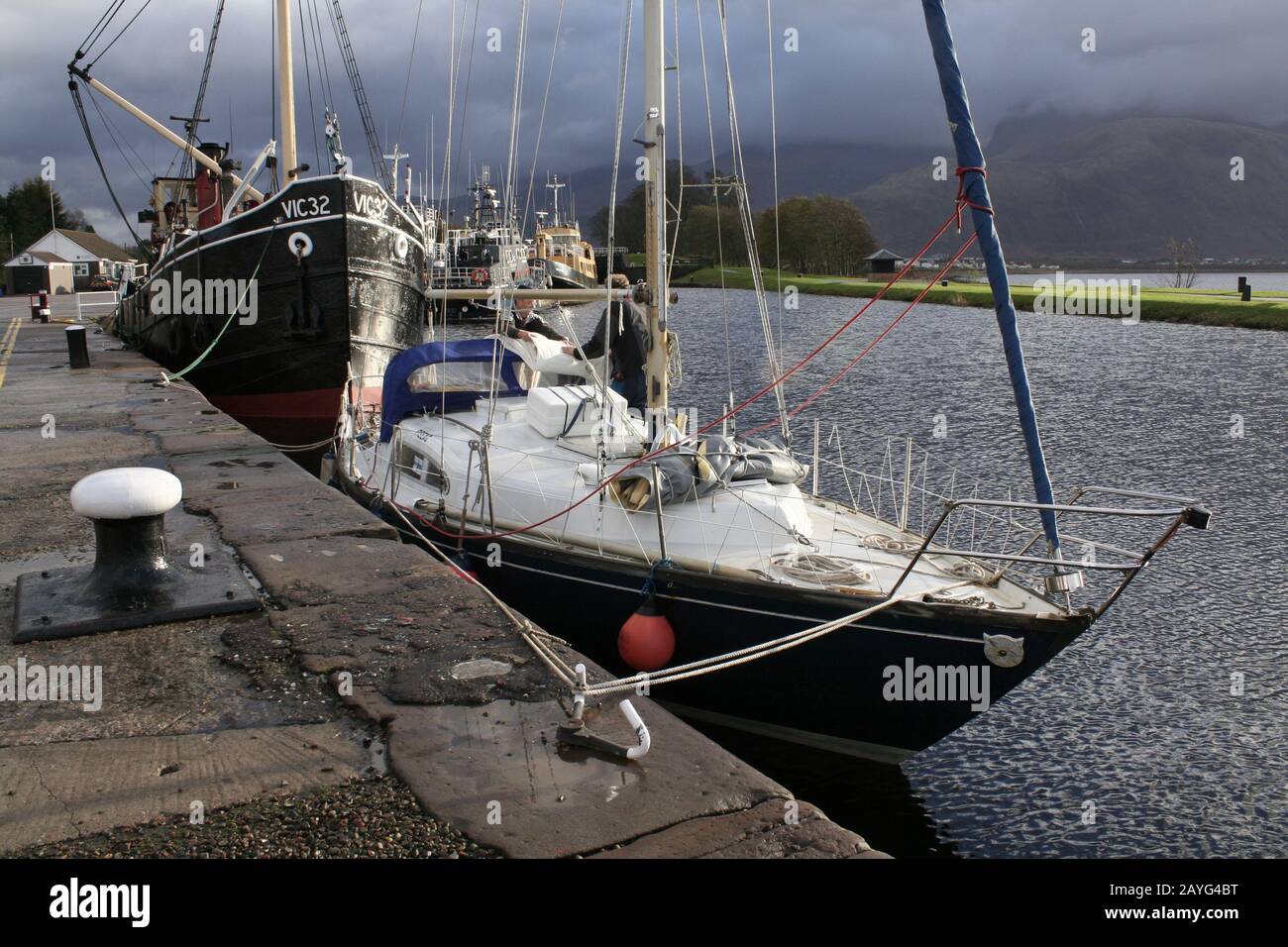 Sailing yacht and Vic 32 Clyde puffer in the lock at Corpach, end of the Caledonian canal, near Fort William, Scotland Stock Photo